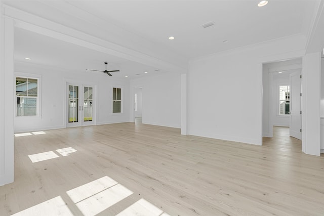 unfurnished living room with baseboards, light wood finished floors, recessed lighting, and crown molding