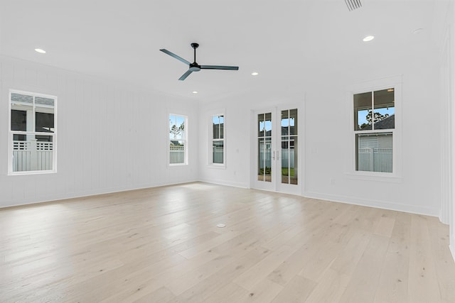 empty room with light wood-type flooring, baseboards, a ceiling fan, and recessed lighting