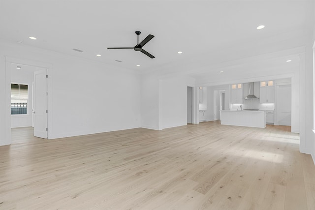 unfurnished living room featuring light wood-style flooring, ceiling fan, crown molding, and recessed lighting