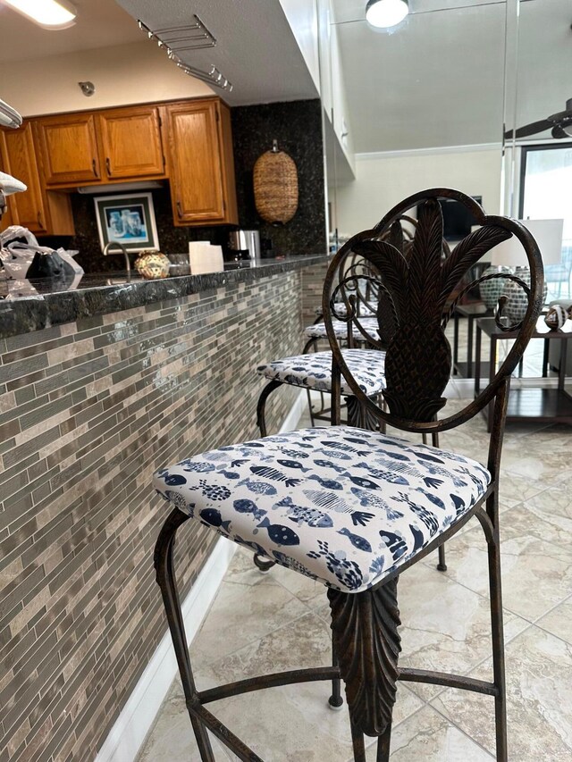 kitchen featuring ceiling fan and light tile floors