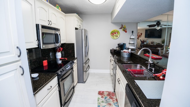 kitchen with ceiling fan, tasteful backsplash, white cabinetry, and stainless steel appliances