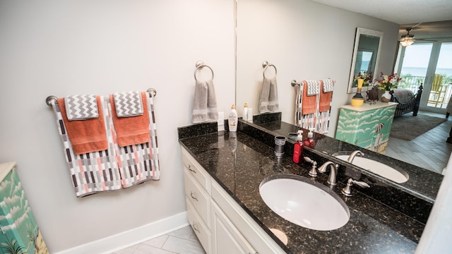 bathroom with ceiling fan, tile floors, and vanity