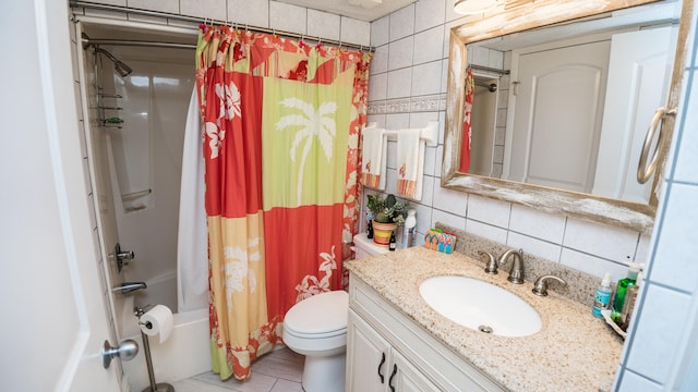 full bathroom featuring tile walls, shower / bath combo with shower curtain, tile floors, toilet, and vanity