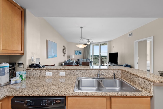 kitchen featuring sink, pendant lighting, light stone countertops, and dishwasher