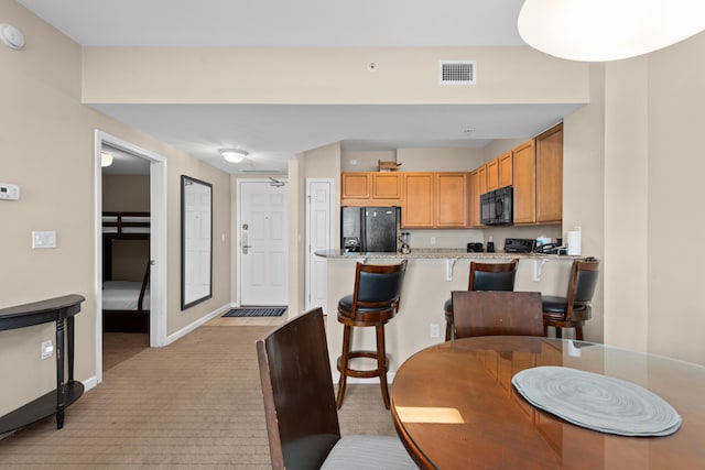 dining space with light colored carpet