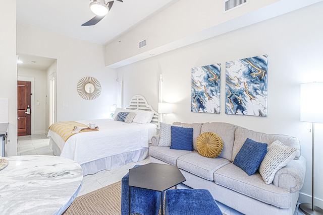 bedroom featuring ceiling fan and light tile floors