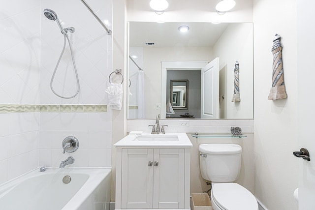 full bathroom featuring tiled shower / bath combo, oversized vanity, and toilet