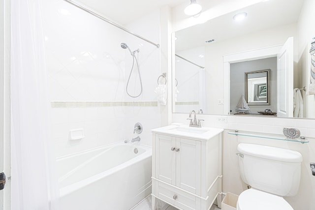 full bathroom featuring tiled shower / bath, toilet, and oversized vanity