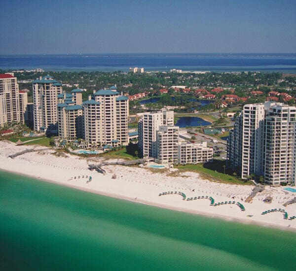 birds eye view of property featuring a beach view and a water view