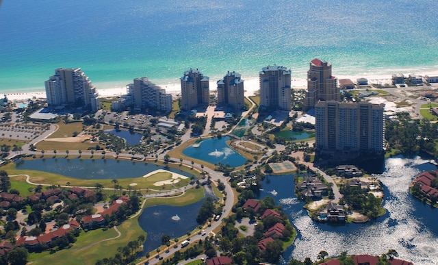 birds eye view of property with a beach view and a water view