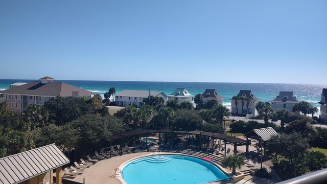 view of pool featuring a patio and a water view