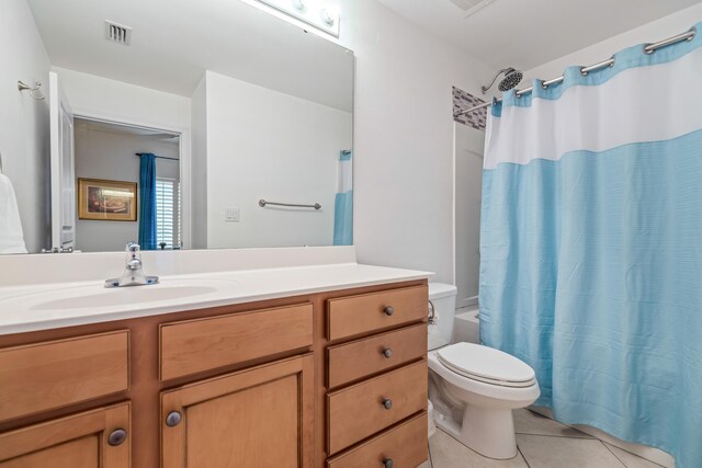 bathroom featuring vanity, toilet, and tile patterned flooring