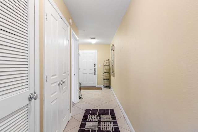 hallway with light tile patterned floors