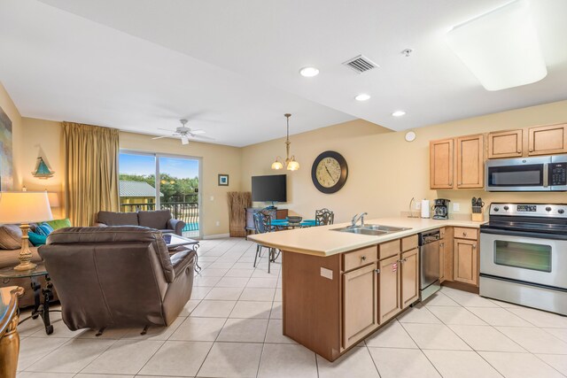 kitchen featuring kitchen peninsula, ceiling fan with notable chandelier, sink, appliances with stainless steel finishes, and light tile patterned floors