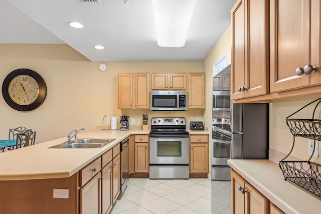 kitchen featuring sink, light tile patterned flooring, kitchen peninsula, and stainless steel appliances