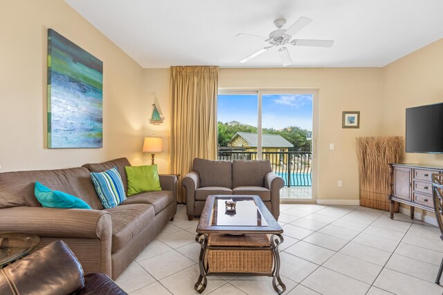 living room featuring light tile patterned floors and ceiling fan