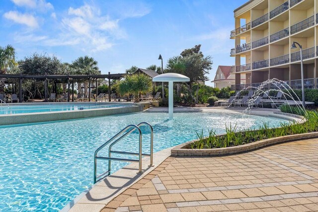 view of swimming pool with pool water feature