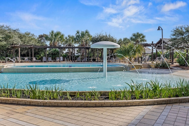 view of swimming pool with pool water feature