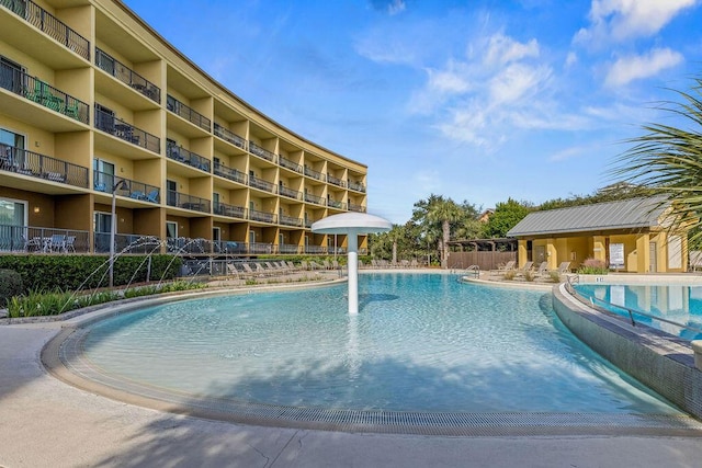 view of swimming pool with pool water feature