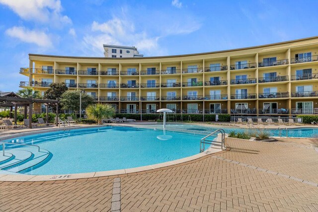 view of swimming pool with pool water feature