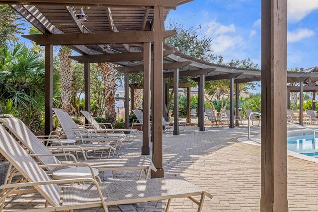 view of patio / terrace with a pergola and a community pool