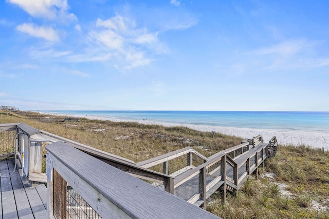 view of home's community featuring a water view and a beach view