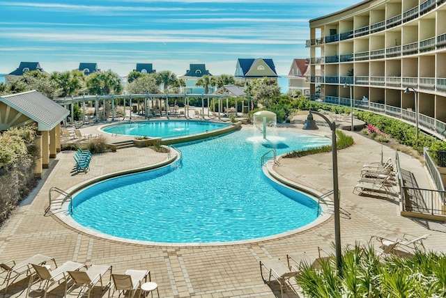 view of swimming pool with a patio and pool water feature