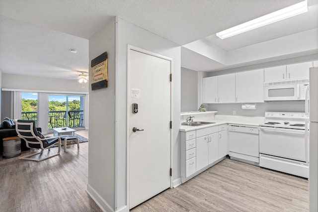 kitchen featuring ceiling fan, sink, white appliances, white cabinetry, and light hardwood / wood-style flooring