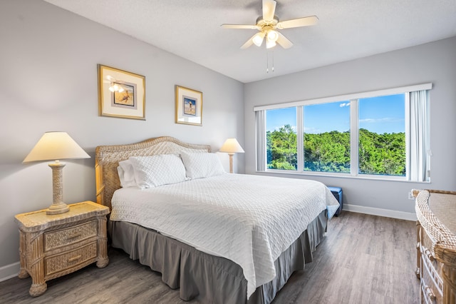 bedroom featuring dark hardwood / wood-style flooring and ceiling fan