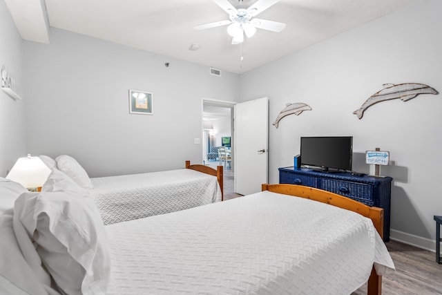 bedroom featuring wood-type flooring and ceiling fan