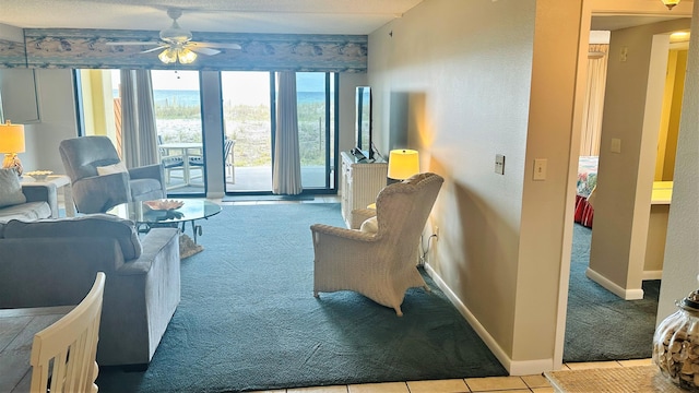 living room featuring light colored carpet, a textured ceiling, and ceiling fan