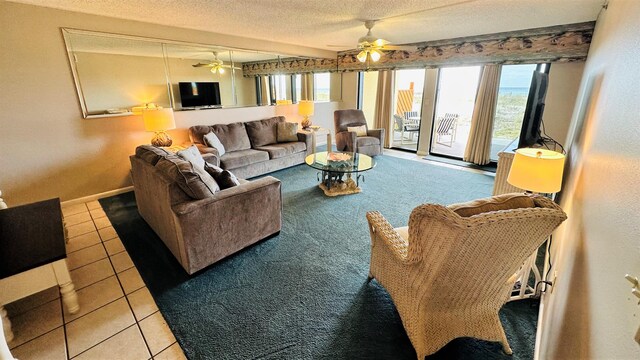 tiled living room featuring a textured ceiling and ceiling fan