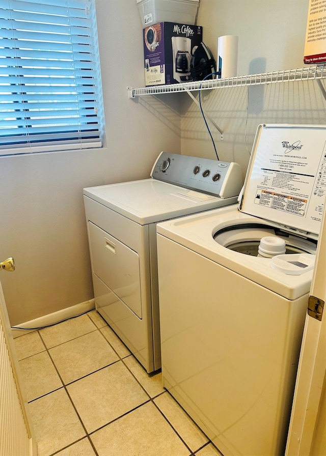 laundry room with separate washer and dryer and light tile floors