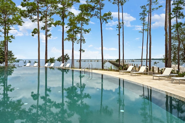 view of pool with a water view