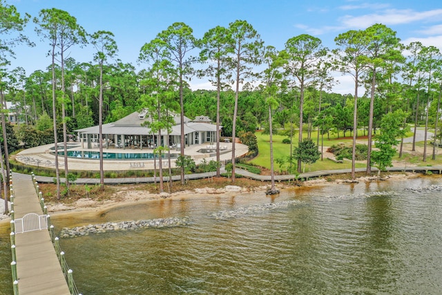 dock area with a water view and a patio