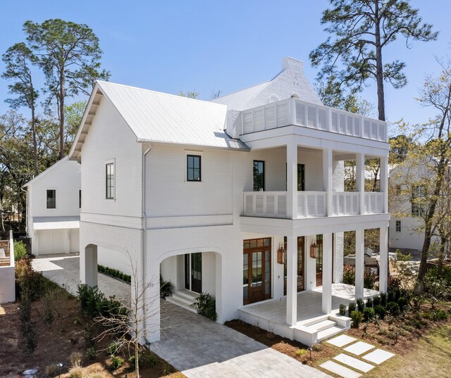 back of house with a patio and a balcony