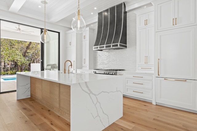 kitchen featuring light hardwood / wood-style floors, ceiling fan, premium range hood, and white cabinetry