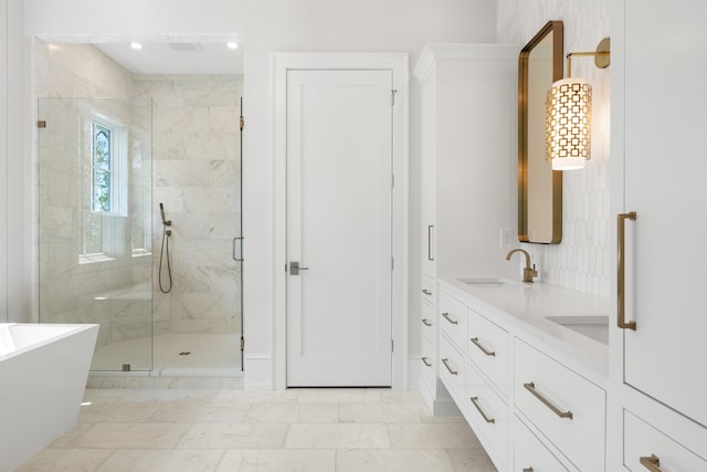 bathroom with double vanity, tile floors, and separate shower and tub