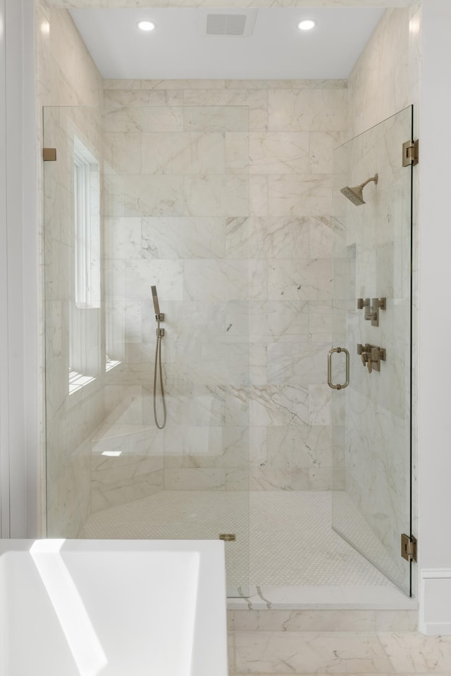 bathroom with a shower with shower door