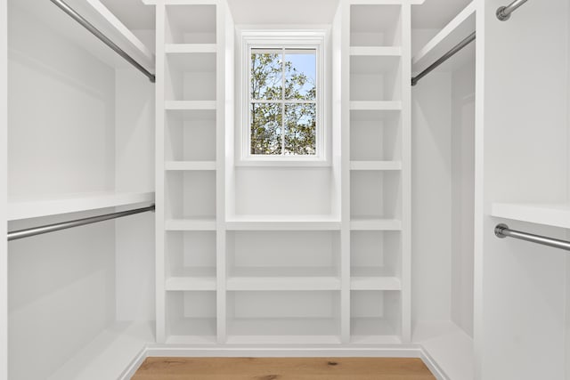 spacious closet with light hardwood / wood-style flooring