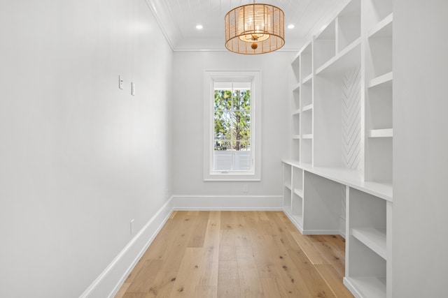 empty room with light hardwood / wood-style floors and crown molding