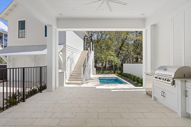 view of patio / terrace featuring a fenced in pool, exterior kitchen, ceiling fan, and area for grilling