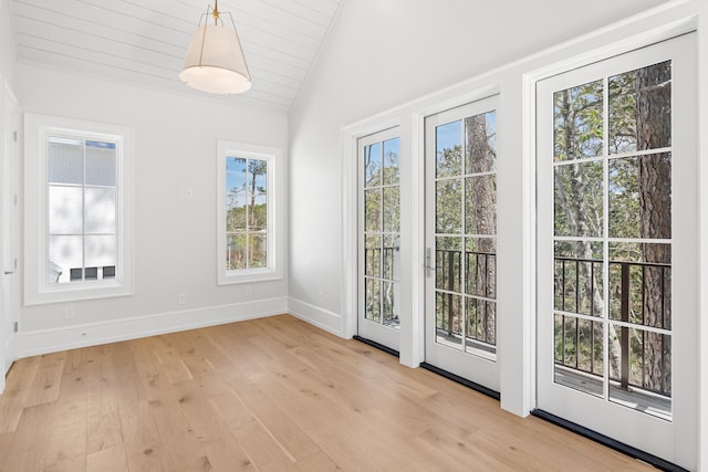 entryway with light hardwood / wood-style floors and lofted ceiling