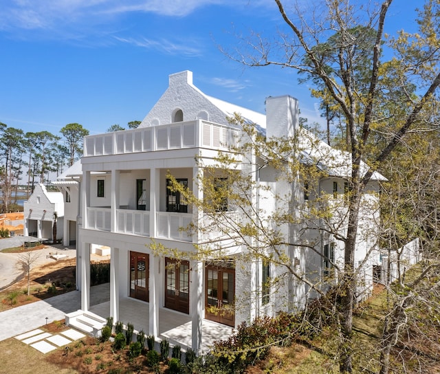 back of property featuring a patio area and french doors