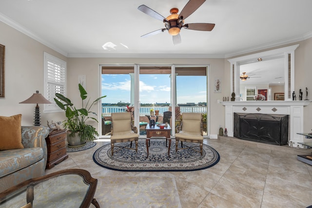 living room with plenty of natural light, ceiling fan, and ornamental molding