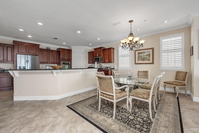 tiled dining space featuring ornamental molding and an inviting chandelier