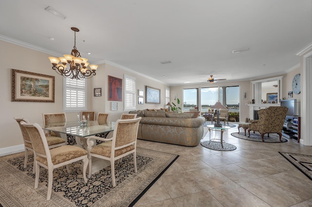 tiled dining area with ceiling fan with notable chandelier, plenty of natural light, and crown molding