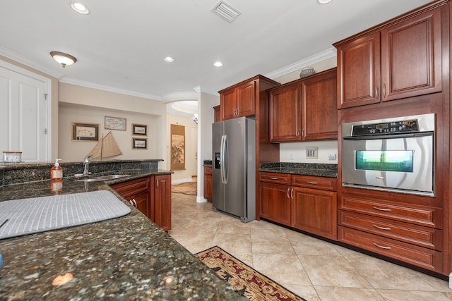 kitchen with light tile flooring, crown molding, stainless steel appliances, sink, and dark stone counters