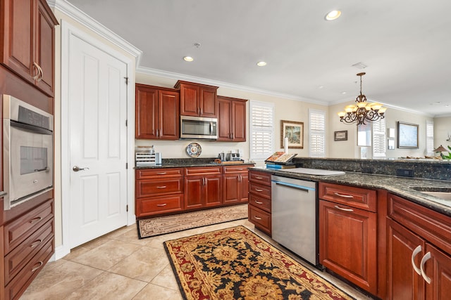 kitchen with appliances with stainless steel finishes, light tile floors, a notable chandelier, decorative light fixtures, and ornamental molding