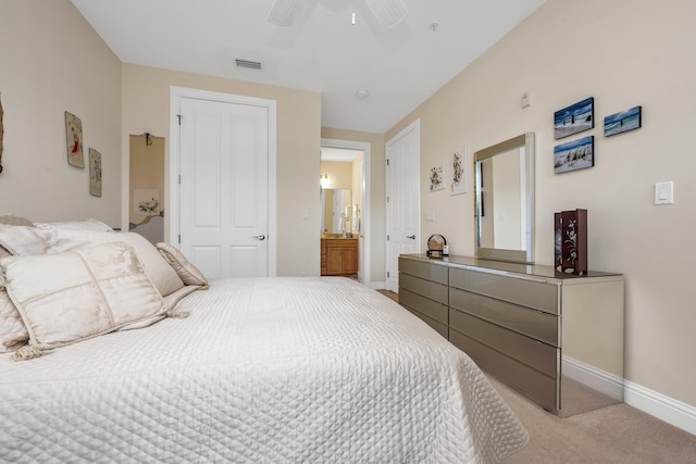 carpeted bedroom featuring ceiling fan and ensuite bathroom